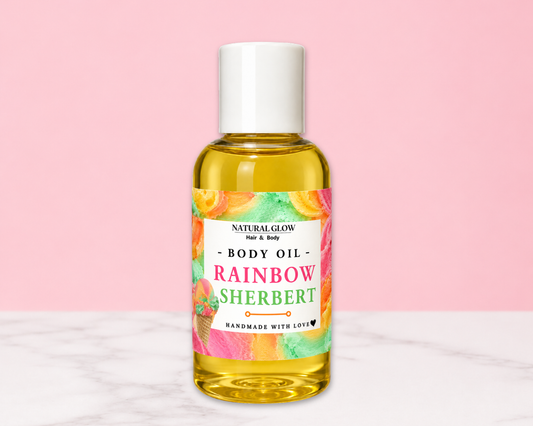 A bottle of Natural Glow Rainbow Sherbert body oil with a white cap and a colorful tropical label, set against a pink background with a white marble surface.