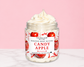 Natural Glow Candy Apple whipped body butter in a jar with cream-colored butter swirl, pink background, and white marble surface