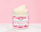 Natural Glow Bubblegum whipped body butter in a jar with cream-colored butter swirl, pink background, and white marble surface