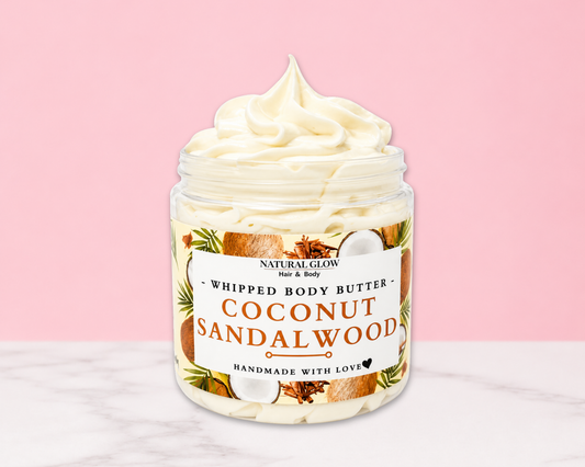 Natural Glow Coconut Sandalwood whipped body butter in a jar with cream-colored butter swirl, pink background, and white marble surface
