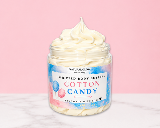 Natural Glow Cotton Candy whipped body butter in a jar with cream-colored butter swirl, pink background, and white marble surface