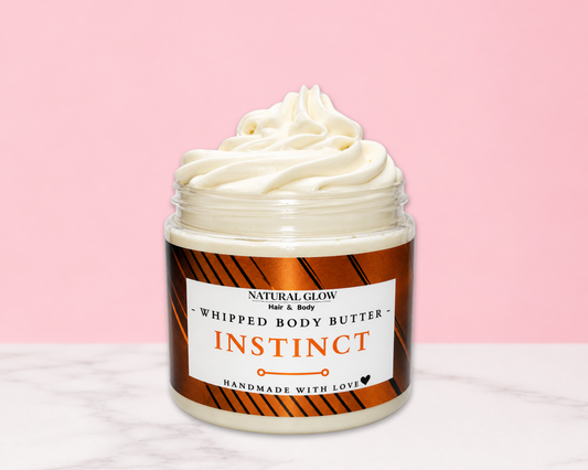Natural Glow Instinct mens whipped body butter in a jar with cream-colored butter swirl, pink background, and white marble surface