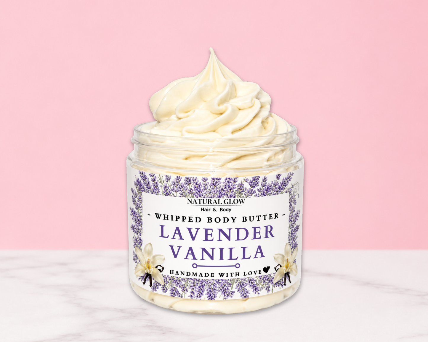 Natural Glow Lavender Vanilla whipped body butter in a jar with cream-colored butter swirl, pink background, and white marble surface