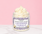 Natural Glow Lavender Vanilla whipped body butter in a jar with cream-colored butter swirl, pink background, and white marble surface
