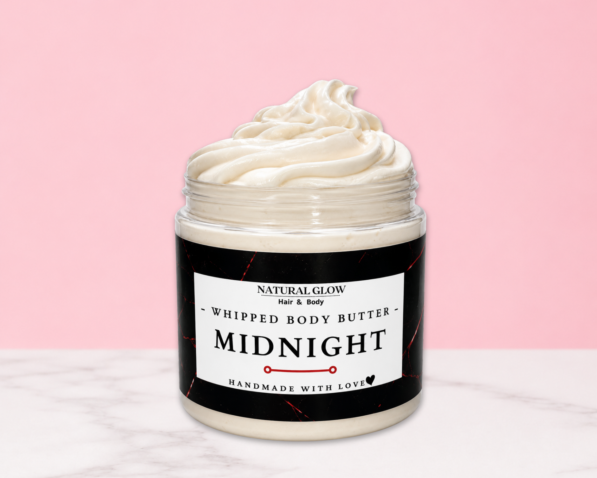 Natural Glow Midnight mens whipped body butter in a jar with cream-colored butter swirl, pink background, and white marble surface