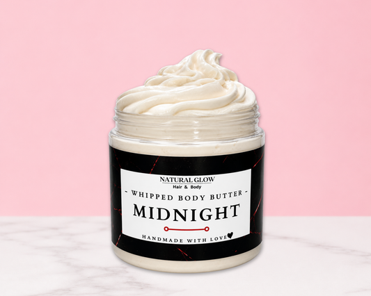 Natural Glow Midnight mens whipped body butter in a jar with cream-colored butter swirl, pink background, and white marble surface