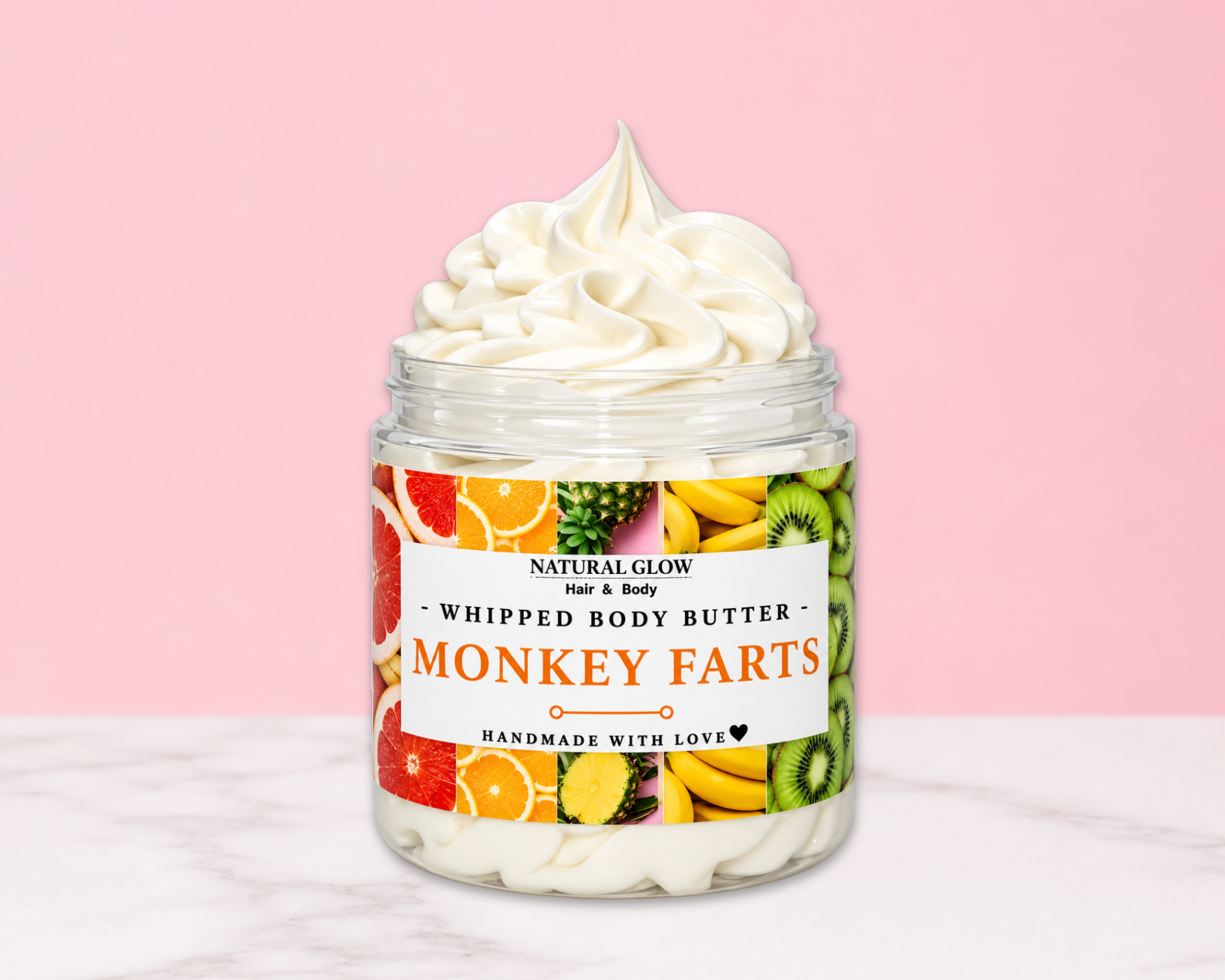 Natural Glow Monkey Farts whipped body butter in a jar with cream-colored butter swirl, pink background, and white marble surface