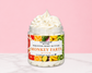 Natural Glow Monkey Farts whipped body butter in a jar with cream-colored butter swirl, pink background, and white marble surface