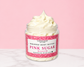 Natural Glow Pink Sugar whipped body butter in a jar with cream-colored butter swirl, pink background, and white marble surface