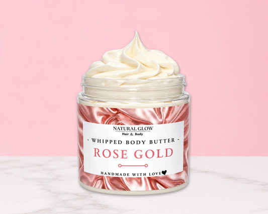 Natural Glow Rose Gold whipped body butter in a jar with cream-colored butter swirl, pink background, and white marble surface