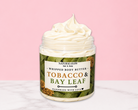 Natural Glow Tobacco & Bay Leaf  men's whipped body butter in a jar with cream-colored butter swirl, pink background, and white marble surface
