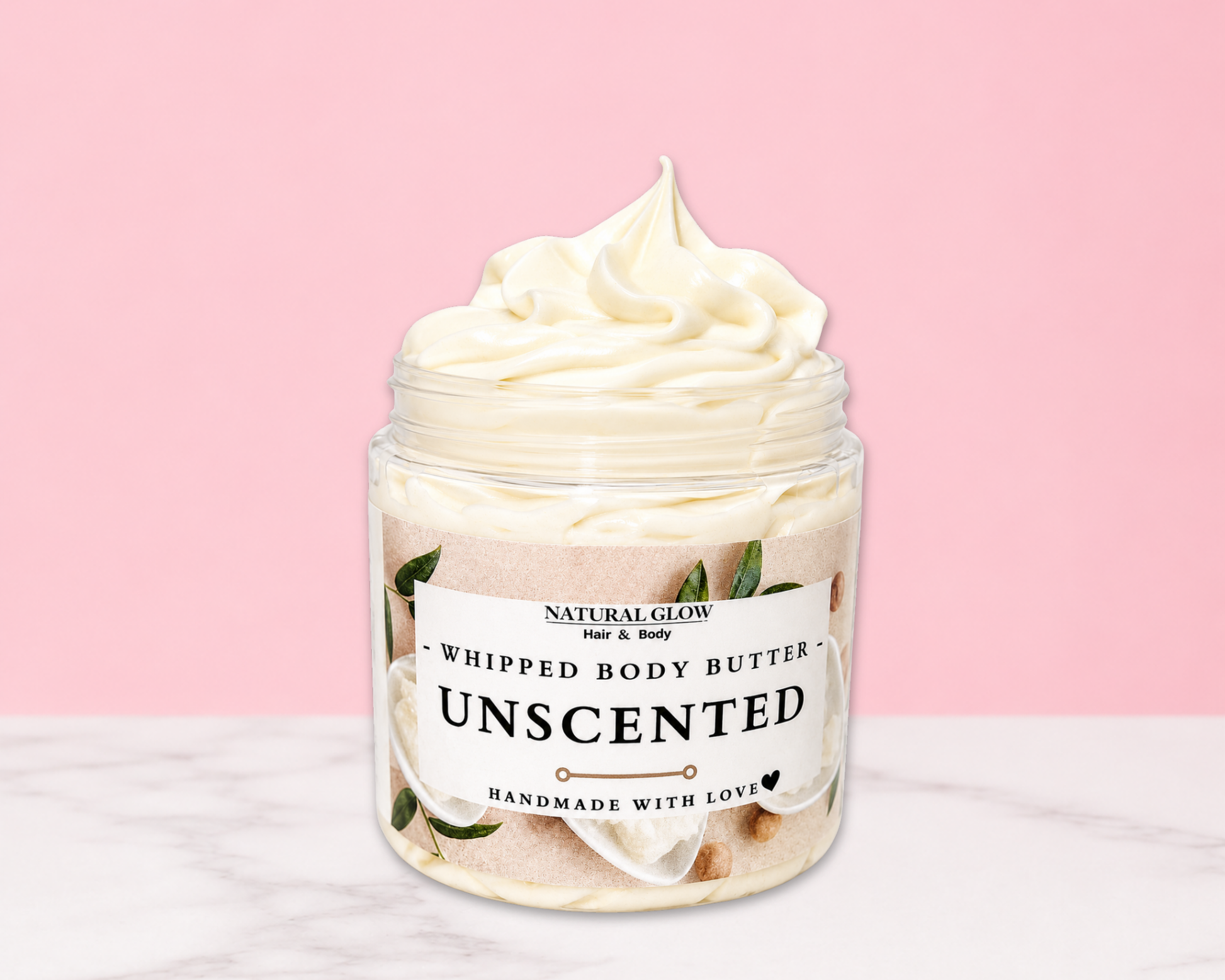 Natural Glow Unscented whipped body butter in a jar with cream-colored butter swirl, pink background, and white marble surface