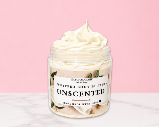 Natural Glow Unscented whipped body butter in a jar with cream-colored butter swirl, pink background, and white marble surface