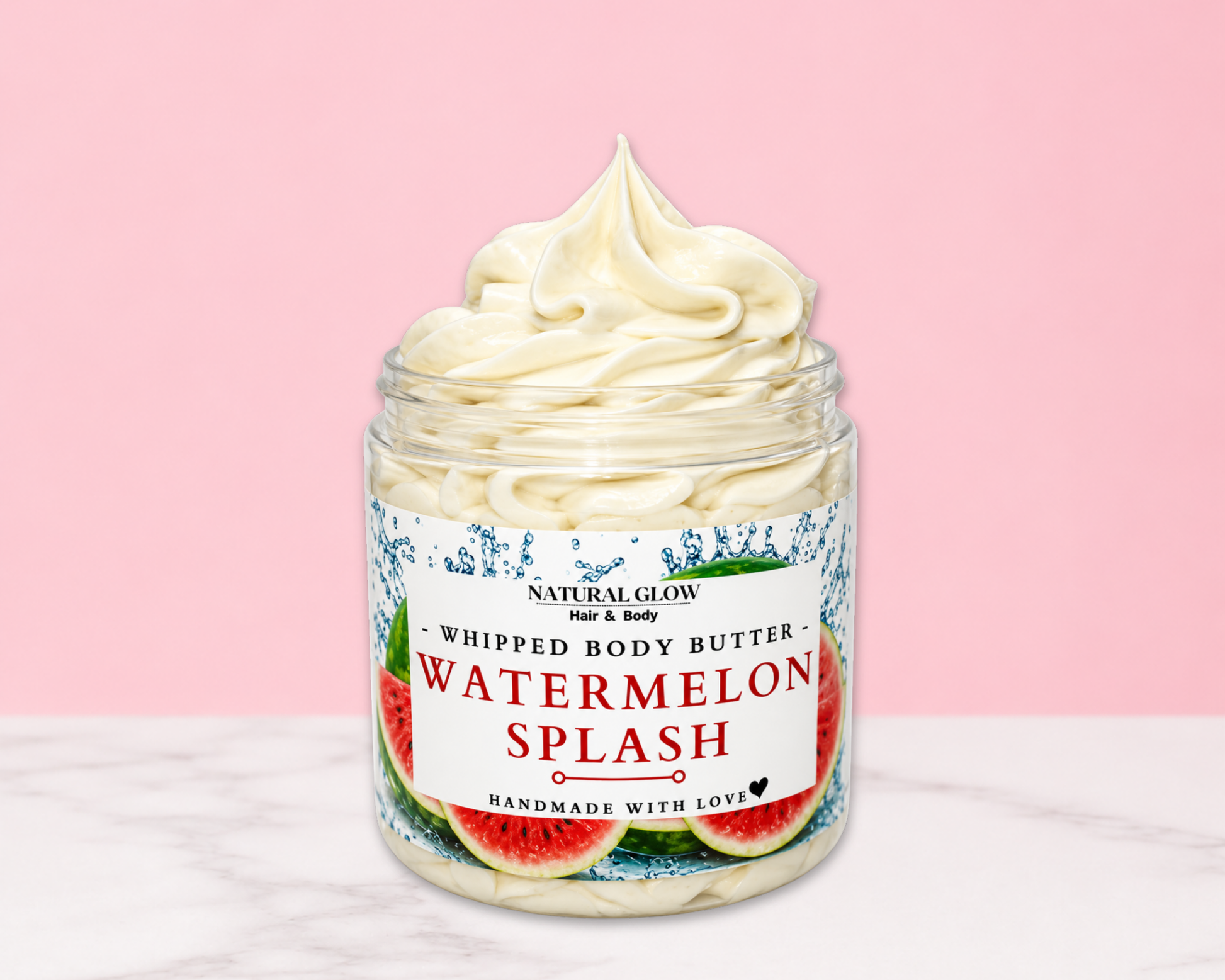 Natural Glow Watermelon Splash whipped body butter in a jar with cream-colored butter swirl, pink background, and white marble surface