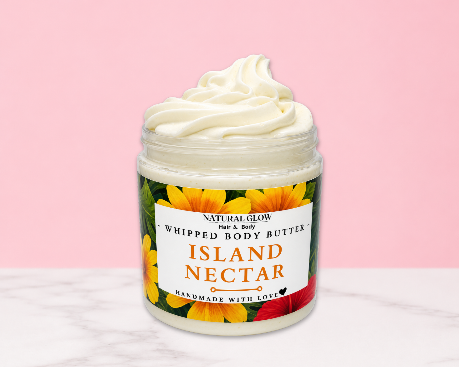 Natural Glow Island Nectar whipped body butter in a jar with cream-colored butter swirl, pink background, and white marble surface